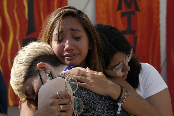 Mitzi Jonelle Tan, of the Philippines, embraces Adriana Calderon Hernandez, right, and Line Niedeggen, left, at the end of a protest against fossil fuels during the COP28 U.N. Climate Summit, Wednesday, Dec. 13, 2023, in Dubai, United Arab Emirates.