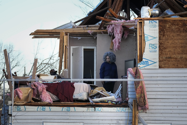 Tonya Osborne looks over the damage to her home in Nashville, Tennessee.